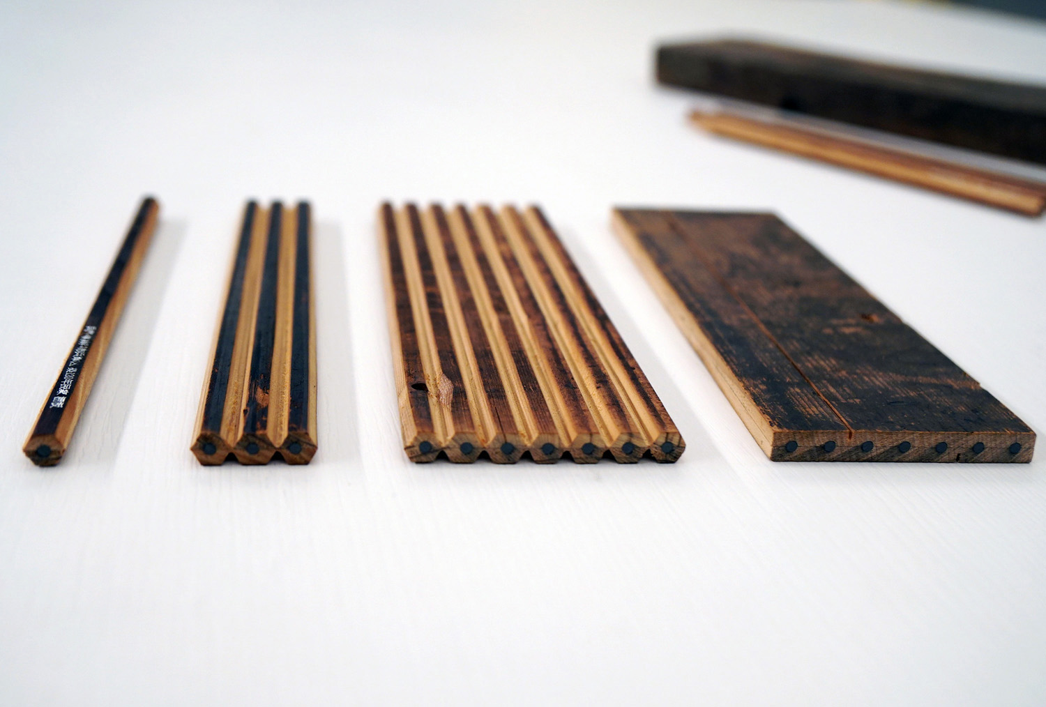 Shaving and cutting a wood board with lead in the middle to make pencils